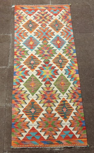 A white, green and turquoise ground Chobi Kilim runner with all over diamond design 198cm x 70cm 