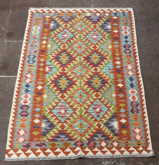 A white and green ground Chobi Kilim rug with all over diamond design 190cm x 126cm 