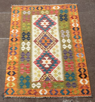 A white, orange and green ground Chobi Kilim rug with all over geometric design 152cm x 100cm 