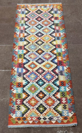 A yellow, black and white ground Chobi Kilim runner with all over diamond design 245cm x 83cm 