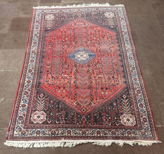 A red, blue and white ground Persian carpet with diamond medallion to the centre within a multi row border 296cm x 193cm 