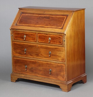 An Edwardian inlaid mahogany bureau with fall front revealing a well fitted interior above 2 short and 3 long drawers with brass drop handles, raised on bracket feet 102cm h x 94cm w x 49cm d 