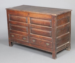 A mid 18th Century oak mule chest with hinged lid and iron lock, the base fitted two short drawers below four fielded rectangular panels raised on block supports 91cm h x 137cm w x 59cm d 