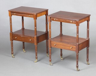 A pair of Georgian style crossbanded mahogany two tier lamp tables, base fitted a drawer, raised on turned supports, brass caps and casters 64cm h x 43cm w x 30cm d 