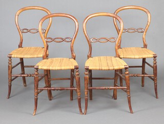 A set of 4 Victorian beech framed balloon back dining chairs with carved mid rails and woven cane seats, raised on cabriole supports 82cm h x 39cm w x 36cm d (seats 20cm x 21cm) 