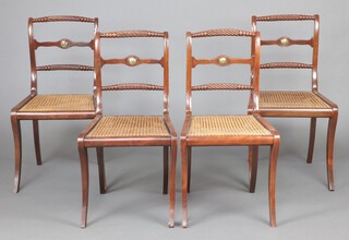 A set of 4 19th Century Regency style mahogany framed rope back dining chairs with shaped mid rails and woven cane seats, raised on front and rear sabre supports 