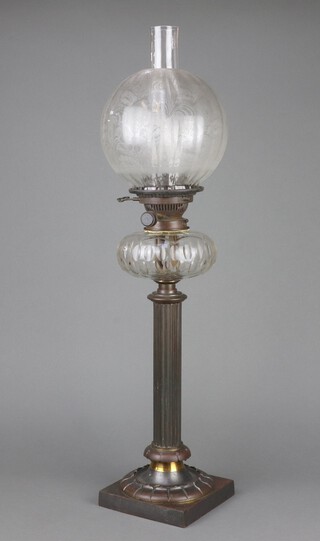 A Victorian cut glass oil lamp reservoir raised on a metal reeded column on a square base complete with etched glass shade and chimney 73cm h 