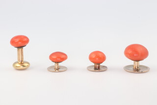 Four yellow gold, testing as 14ct gold mounted coral studs 