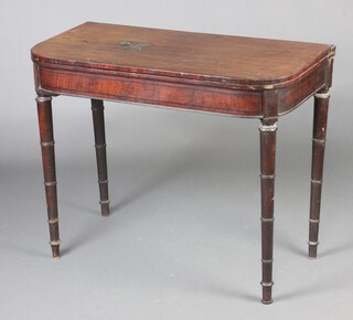 A Georgian mahogany D shaped tea/card table raised on turned supports 73cm h x 92cm w x 46cm d 