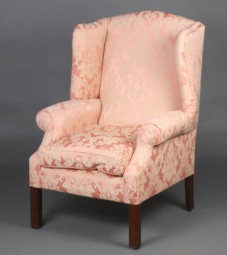 A Georgian style winged armchair upholstered in pink and cream material, raised on square supports 109cm h x 69cm w x 72cm d, inside seat 40cm w x 43cm d