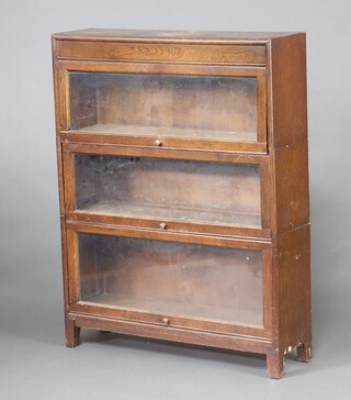 A 1930's light oak Globe Wernicke style 3 tier bookcase, enclosed by a glazed panelled door 113cm h x 87cm w x 25cm d 