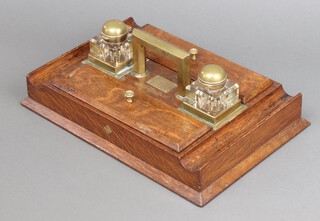 A Victorian oak and glass inkwell fitted 2 square glass bottles with gilt metal caps and pen recesses, marked Presented to Reverend L F Purcell M A July 1892 10cm h x 37cm w x 25cm d 