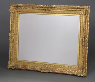 A rectangular plate mirror contained in a 19th Century gilt cushion shaped frame 110cm x 88cm 