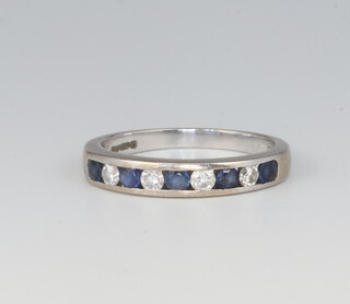 An 18ct white gold sapphire and diamond half eternity ring, the diamonds approx. 0.2ct, the sapphires 0.2ct, size O 1/2, 3.7 grams 