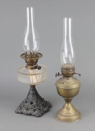 A Victorian glass oil lamp reservoir raised on a pierced iron base 30cm h x 15cm diam. and a gilt metal ditto 20cm h x 13cm 