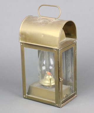 A 19th Century style oil lamp contained in a brass arch shaped case 31cm h x 16cm w x 12cm d 