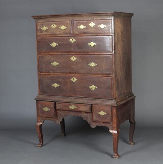 An 18th Century oak chest on stand with moulded cornice, the cross banded drawer fronts with brass escutcheons and swan neck drop handles, fitted 2 short and 3 long drawers, the base fitted 1 long and 1 short drawer 149cm h x 99cm w x 54cm d 