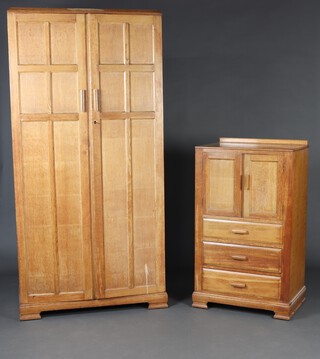 A 1930's light oak bedroom suite comprising wardrobe fitted shelves and hanging space enclosed by panelled doors, raised on bracket feet 183 cm h x 89cm w x 46cm d, a tall boy with raised back enclosed by a panelled door above 3 drawers raised on ogee bracket feet 105cm h x 61cm w x 42cm d and a dressing table fitted 4 drawers on square supports with H framed stretcher 73cm h x 89cm w x 44cm d 