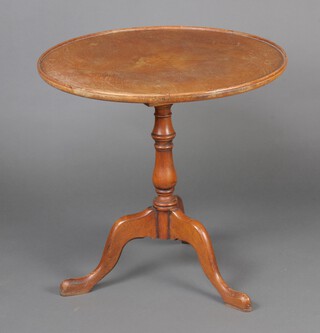 A Georgian style oak tea table with 3/4 saucer top and bird cage action, raised on a pillar and tripod base 67cm h x 69cm diam.  