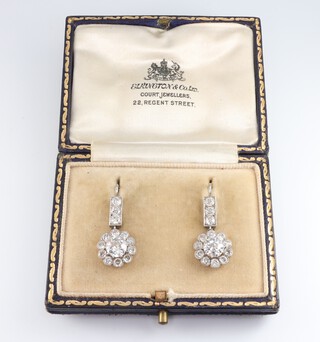 A fine pair of Edwardian white metal, testing as platinum, diamond cluster drop earrings with 3 brilliant cut diamonds supporting 11 diamond cluster drops, total carat weight 2.92ct, 25mm, 4.4 grams, boxed 