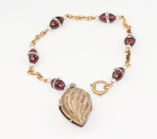 An yellow gold (testing as 14ct) garnet and crystal bracelet 17cm, with a pierced white metal hinged mount 