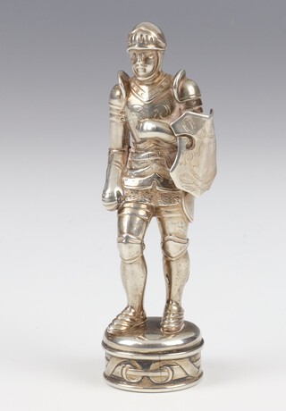 A Victorian white metal desk seal in the form of a standing Knight (lacking sword) with engraved hardstone seal 9cm 