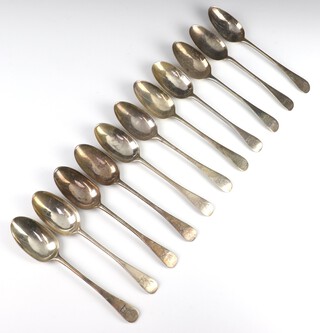 A matched set of 11 silver Old English pattern table spoons with engraved armorial, mixed dates and makers, 650 grams 