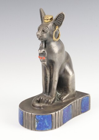 An Egyptian cast silver figure of a seated cat with gilt scarab headdress and coral bead inlay, the base with plaques of lapis lazuli 14cm high, 740 grams 