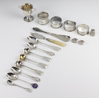 A silver 2 handled trophy cup Birmingham 1951, 4 napkin rings, 8 spoons, pair of cufflinks and a thimble, 212 grams together with a button hook and butter knife 