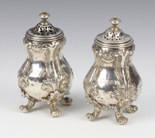 A pair of Victorian repousse silver baluster condiments with engraved armorials and Cayenne and Salt, raised on scrolled feet, 194 grams, London 1841, 9.5cm, maker Robert Hennell III 