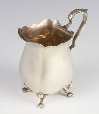 A Queen Anne silver cream jug with S scroll handle on pad feet Birmingham 1942, 104 grams, 10cm 