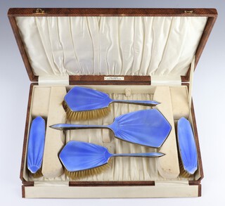 A 5 piece silver and blue guilloche enamel backed dressing table set with hand mirror, 2 hair brushes and 2 clothes brushes, Birmingham 1932, cased 