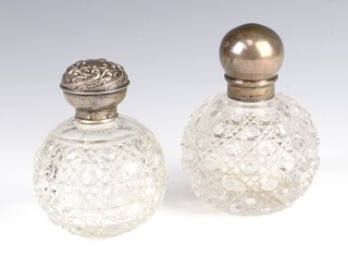 A Victorian silver mounted globular toilet bottle London 1892, 12cm, ditto Birmingham 1904 11cm 