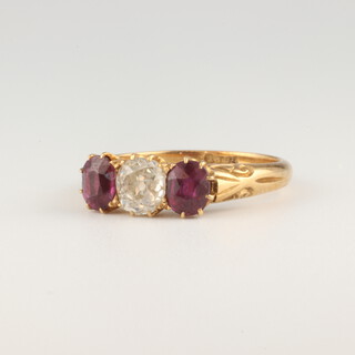 An 18ct yellow gold ring, set a brilliant cut diamond approx. 0.6ct and 2 oval cut rubies approx. 0.3ct, size M 1/2, 3.8 grams 