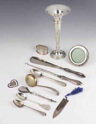 A silver spill vase Birmingham 1979 20cm, a napkin ring, button hook, circular frame, sifter spoon, 4 other spoons, 2 book marks and a shoe horn, weighable silver 122 grams 