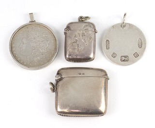 Two Edwardian silver vestas Birmingham 1924, a key ring and a silver mounted Morgan dollar, weighable silver 48 grams 