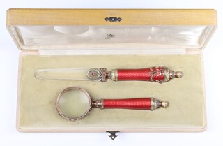 A Faberge style silver gilt and guilloche enamel desk set comprising paper knife with glass blade stamped 56 and HW and eye glass stamped 56 and HW contained in a fitted box 