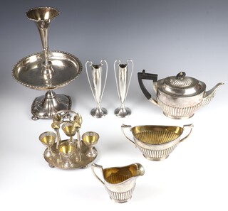 An Edwardian silver plated epergne, a 3 piece demi fluted tea set, an egg cruet and other items of plated ware 