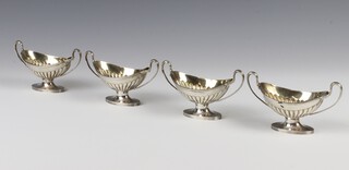 A set of 4 Adam style Victorian silver table salts with demi-fluted decoration and scroll handles 12cm, London 1887, 268 grams 