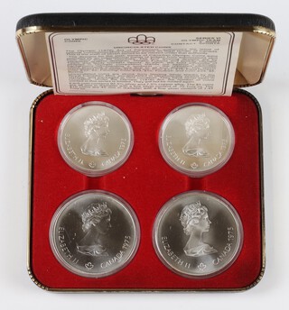 A set of 4 1976 Olympic uncirculated silver coins, 2 five dollars and 2 ten dollars, 146.5 grams 