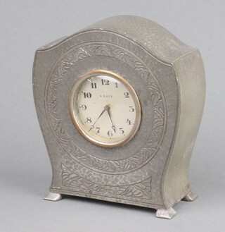 Tudric, an 8 day bedroom timepiece contained in an arch shaped planished pewter case, the base marked Tudric Pewter 10566 13cm x 12cm x 5cm  