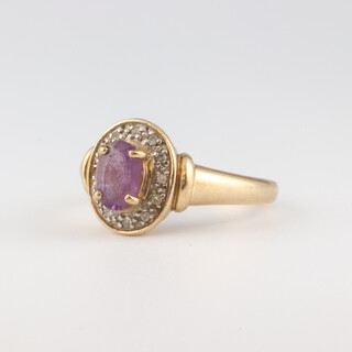 A 9ct yellow gold oval amethyst and diamond cluster ring, 3.2 grams, size N 1/2