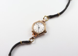 A lady's 9ct yellow gold wristwatch with gem set winder, in a 20mm case with leather strap 