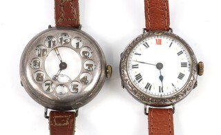 A gentleman's silver half hunter wristwatch with seconds at 6 o'clock, the pierced cover revealing the numerals, contained in a 35mm case with presentation inscription, a ditto with Roman numerals and red 12 contained in engraved case 35mm (both not working) both on leather straps  