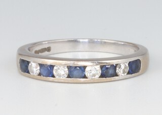 An 18ct white gold sapphire and diamond half eternity ring, the diamonds approx. 0.2ct, the sapphires 0.2ct, size O 1/2, 3.7 grams 