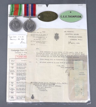 A pair of medals to Squadron Leader C G K Thompson M.B, D.P.H, comprising Defence and War medal, together with an Air Ministry letter confirming award, an oval plastic name plate and an oval disc marked Doctors Cabin 