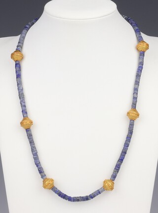 An early lapis lazuli necklace interspersed with 6 yellow gold, testing as 22ct, beads 47cm 