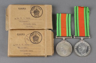 A family group of medals, mother and daughter comprising 2 Defence medals with cardboard postage boxes marked Mrs F J Cook and Miss G V Cook, Hillcrest, Newlands Road, Crawley 