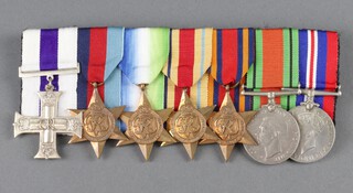 A group of 7 medals comprising facsimile George VI issue Military Cross, 1939-45 Star, Atlantic Star, Africa Star, Burma Star, Defence and War medal, cork mounted 