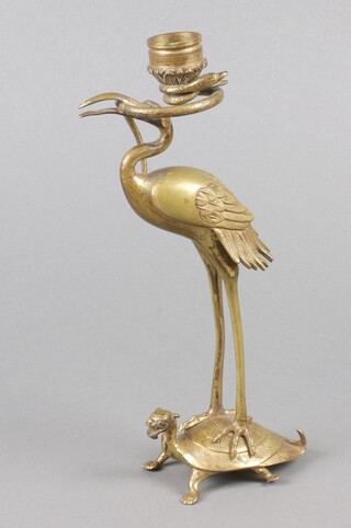 A 19th Century Japanese polished bronze candlestick in the form of a stork standing on a turtle 27cm 